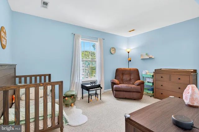 a bedroom with furniture and a window