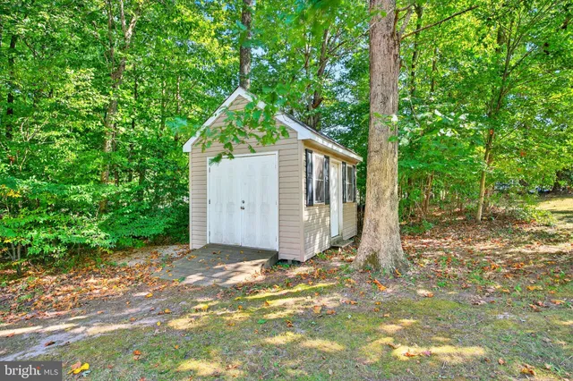 an aerial view of a house with a yard and large trees