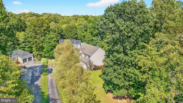 an aerial view of a house with a yard