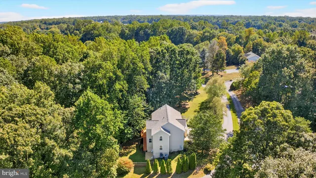 a view of a patio with table and chairs and wooden fence