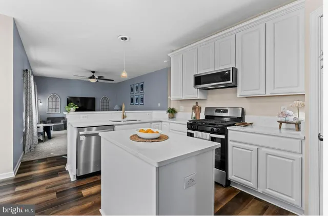 a kitchen with a stove a sink and a microwave