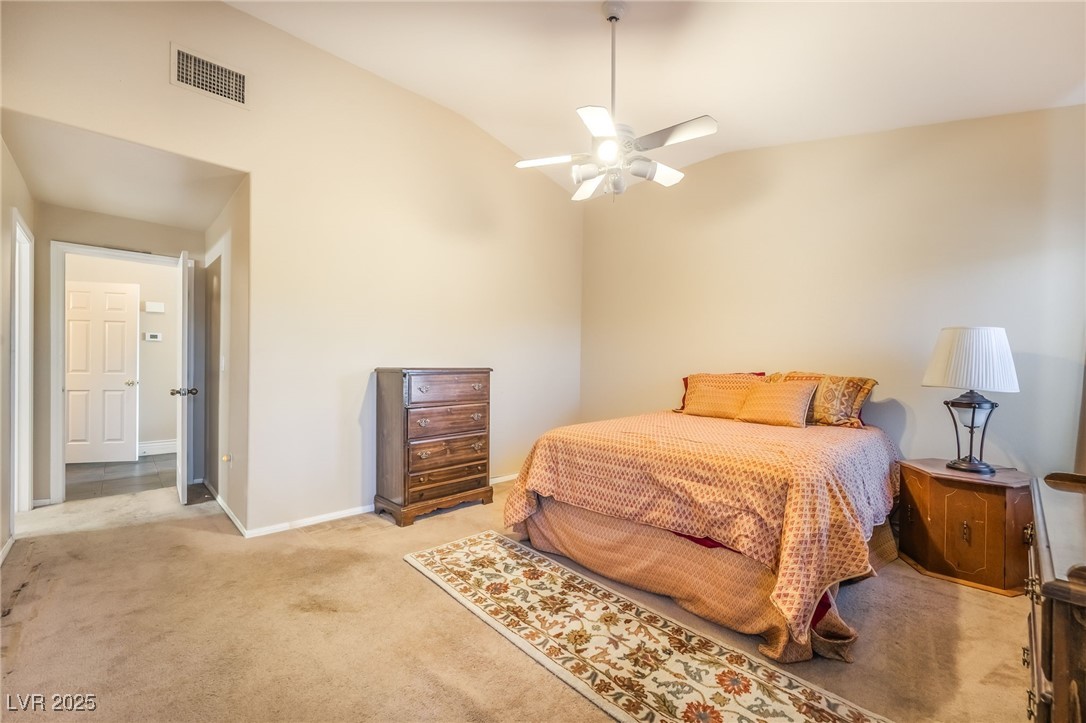 1509 Dallas Terrace, Unit 294 Henderson, NV 89014 - Photo 11 of 27 Bedroom featuring carpet floors, lofted ceiling, and a ceiling fan