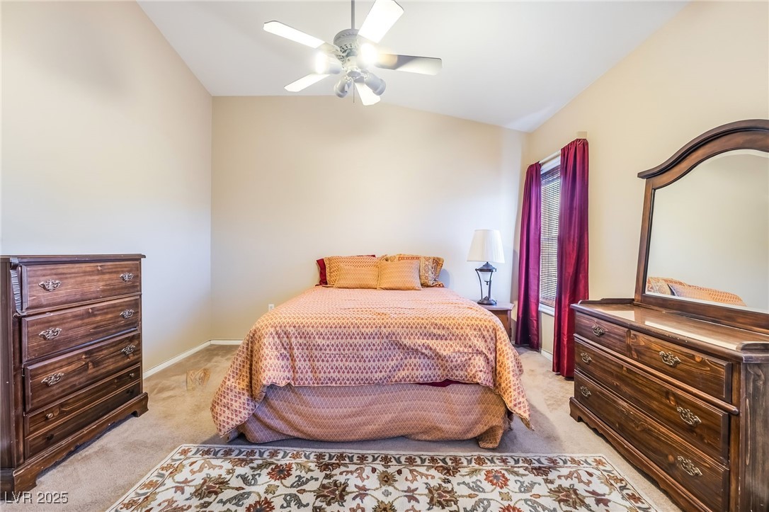1509 Dallas Terrace, Unit 294 Henderson, NV 89014 - Photo 12 of 27 Bedroom with lofted ceiling, light carpet, and ceiling fan