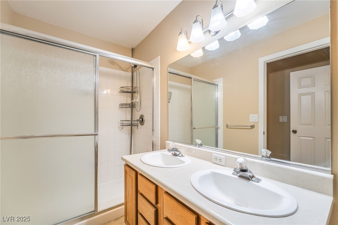 1509 Dallas Terrace, Unit 294 Henderson, NV 89014 - Photo 14 of 27 Bathroom featuring double vanity and a shower stall