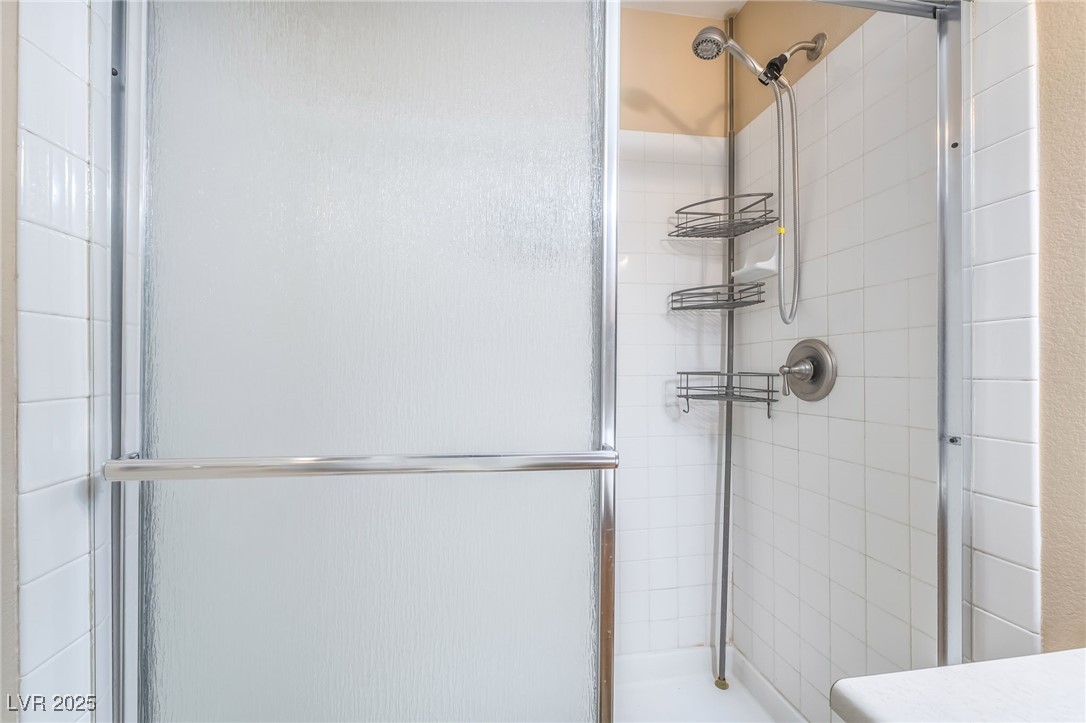 1509 Dallas Terrace, Unit 294 Henderson, NV 89014 - Photo 15 of 27 Full bathroom with a tile shower and vanity