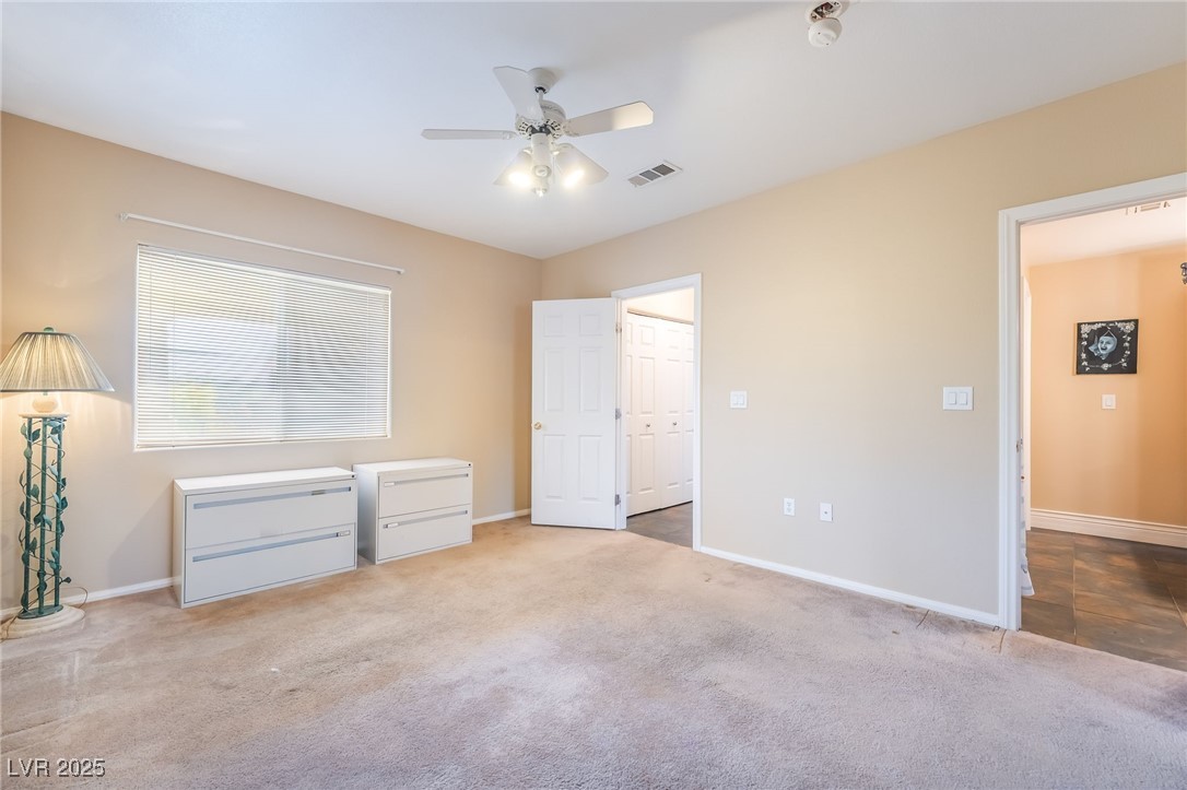 1509 Dallas Terrace, Unit 294 Henderson, NV 89014 - Photo 17 of 27 Unfurnished bedroom featuring carpet and a ceiling fan