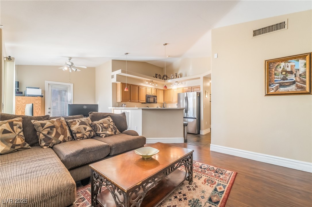 1509 Dallas Terrace, Unit 294 Henderson, NV 89014 - Photo 2 of 27 Living room with dark wood finished floors, ceiling fan, and lofted ceiling