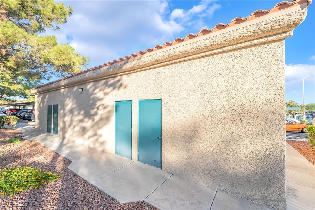 1509 Dallas Terrace, Unit 294 Henderson, NV 89014 - Photo 22 of 27 Rear view of property with a tiled roof and stucco siding