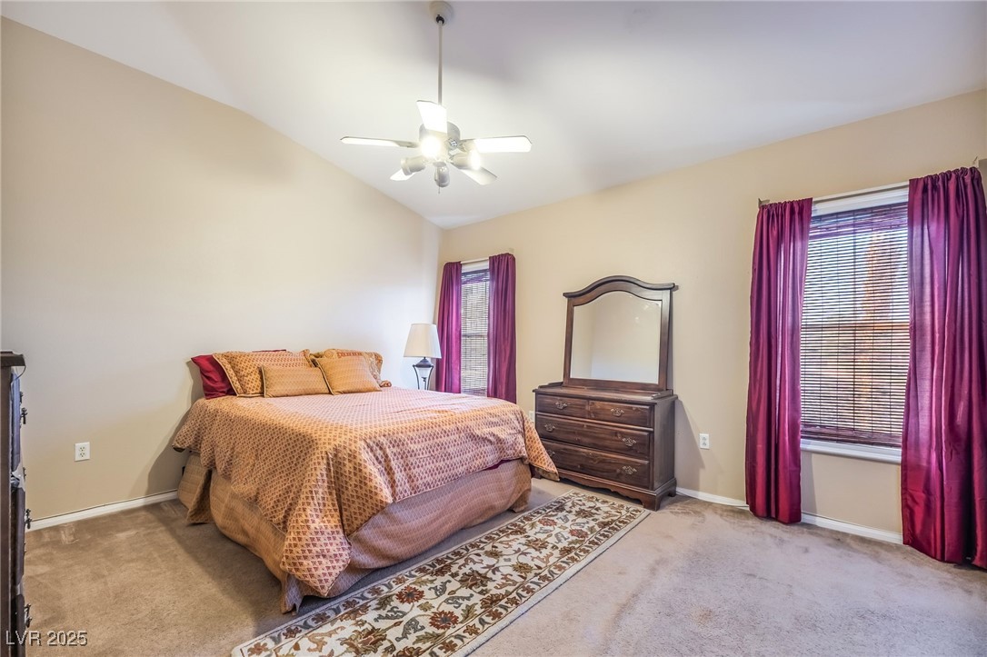 1509 Dallas Terrace, Unit 294 Henderson, NV 89014 - Photo 10 of 27 Bedroom featuring lofted ceiling, light carpet, and ceiling fan