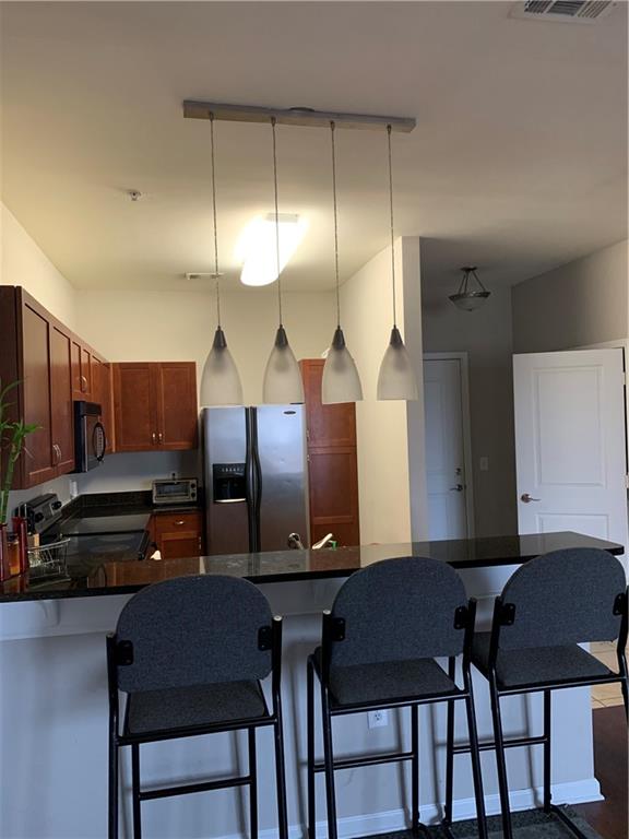 a kitchen with a table chairs and a refrigerator