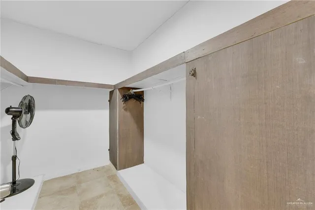 a view of a backyard with a chair and potted plant