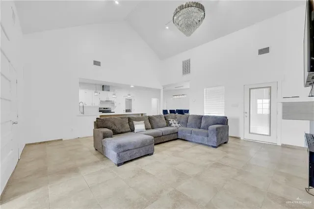 a living room with furniture and a chandelier