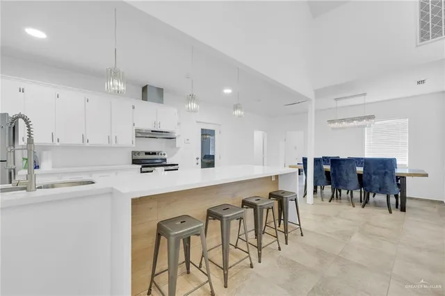 a kitchen with appliances a sink and cabinets