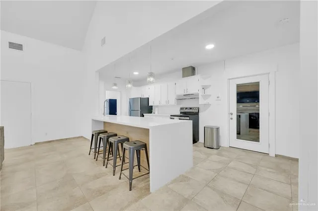 a kitchen with a refrigerator and a sink