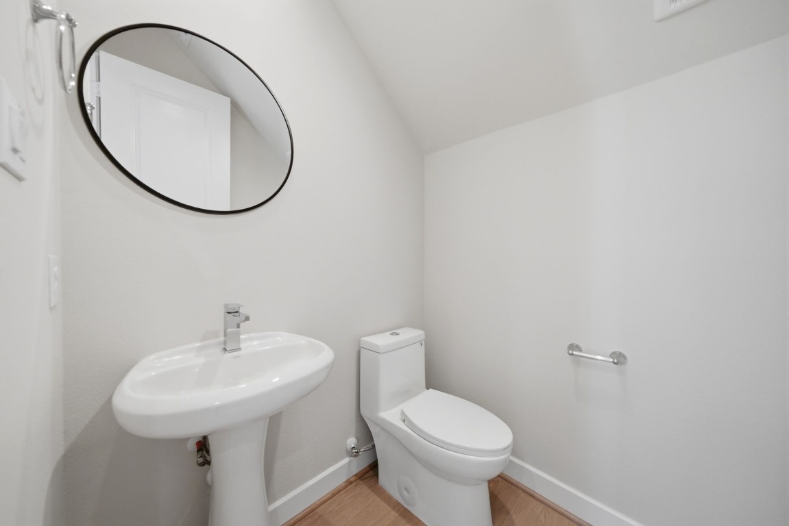 5906 Jasper Jones Way Houston, TX 77091 - Photo 16 of 22 a bathroom with a sink a toilet and a mirror
