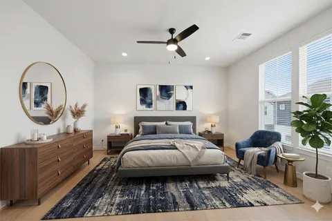 a bedroom with a bed a mirror and a potted plant