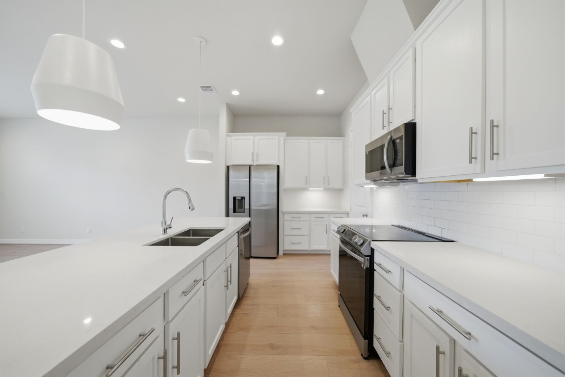 5906 Jasper Jones Way Houston, TX 77091 - Photo 6 of 22 a kitchen with stainless steel appliances granite countertop a sink a stove and a refrigerator