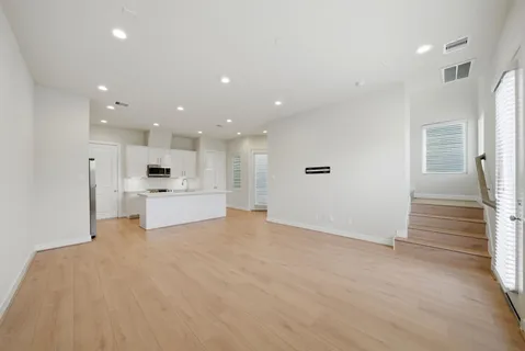 a view of kitchen with kitchen island a sink stainless steel appliances and cabinets
