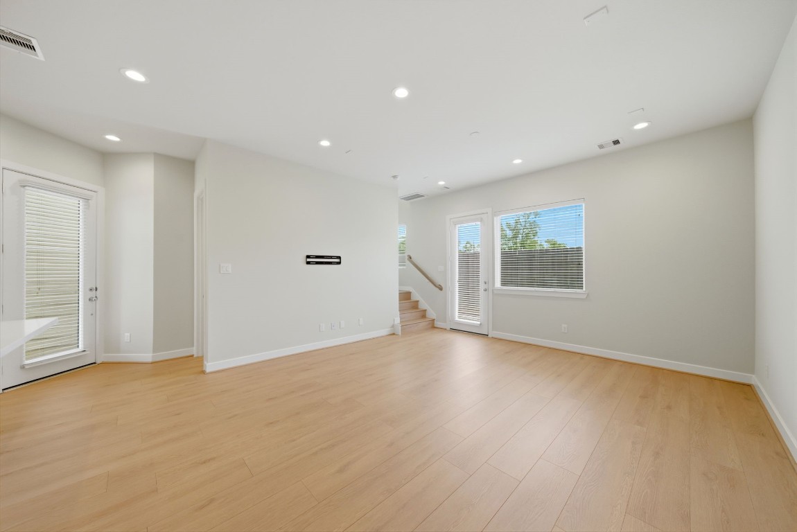 5906 Jasper Jones Way Houston, TX 77091 - Photo 9 of 22 an empty room with wooden floor and windows