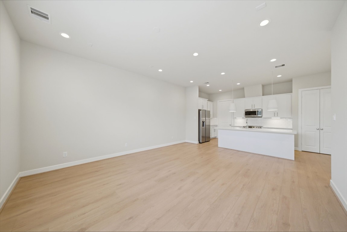 5906 Jasper Jones Way Houston, TX 77091 - Photo 10 of 22 a view of kitchen with kitchen island a sink wooden floor and kitchen island