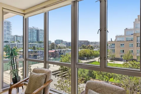 a view of room with balcony and furniture