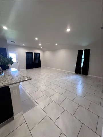 a kitchen with stainless steel appliances kitchen island granite countertop a stove a refrigerator and a sink