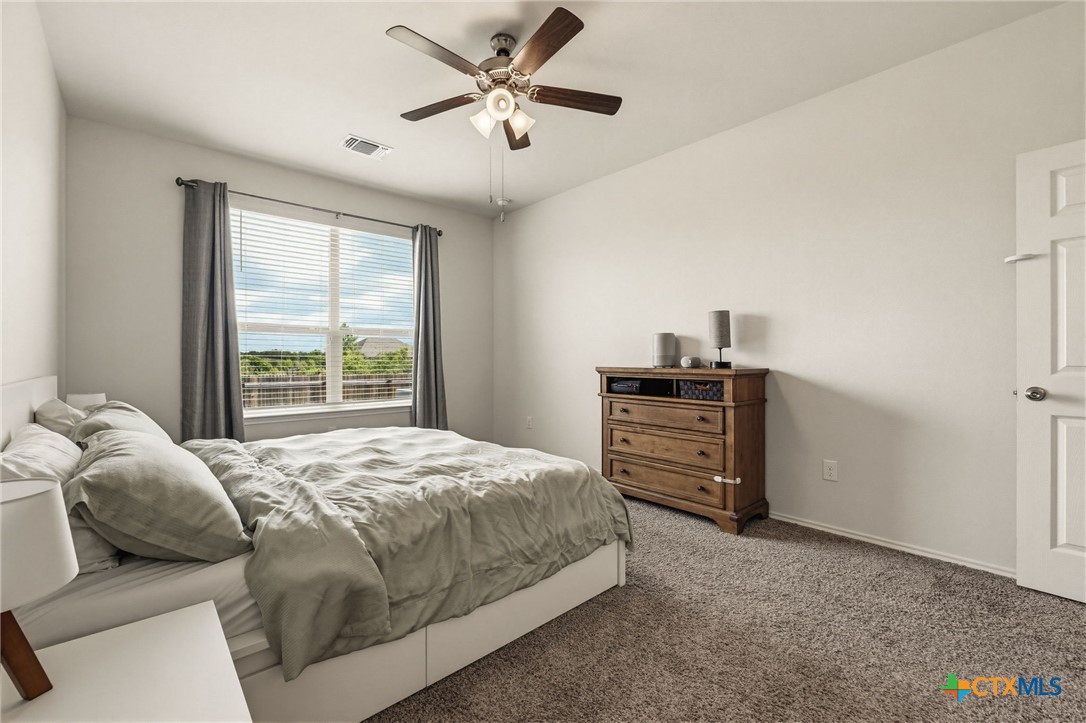 2044 Mallard Court Copperas Cove, TX 76522 - Photo 14 of 41 a bedroom with a bed and a chandelier