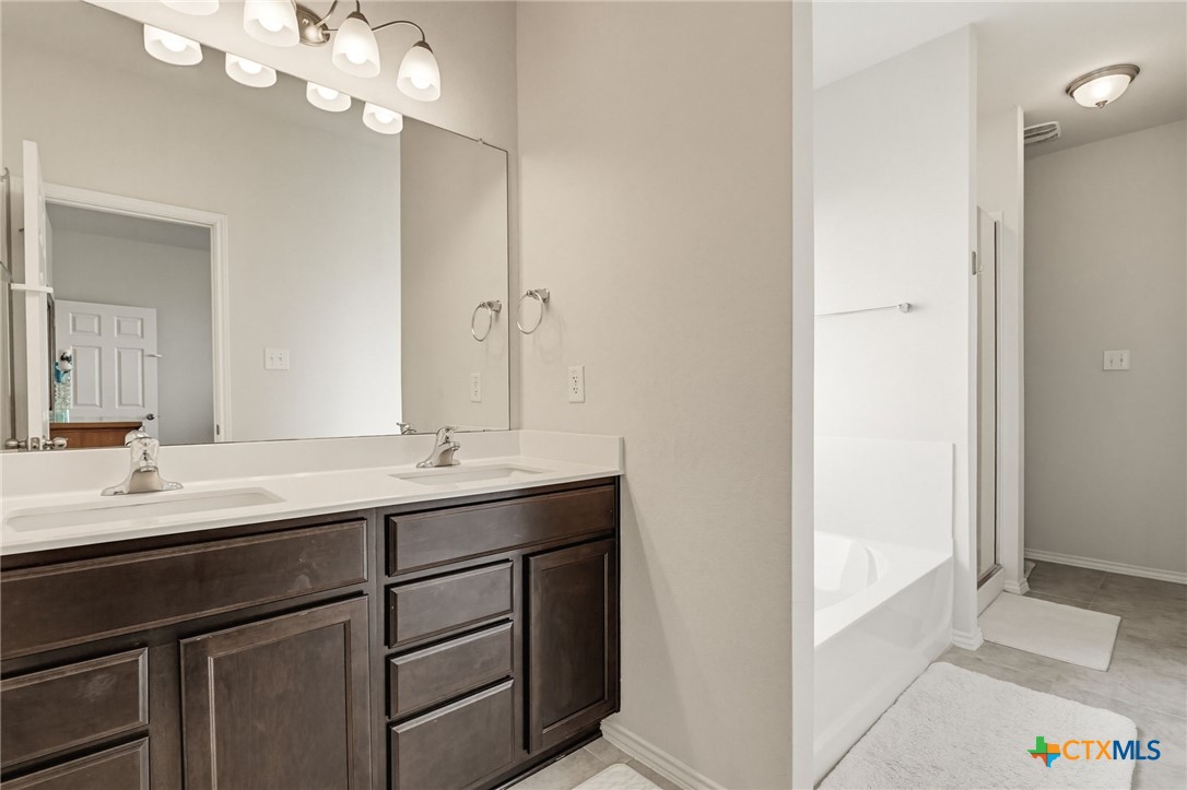 2044 Mallard Court Copperas Cove, TX 76522 - Photo 16 of 41 a bathroom with a double vanity sink and a mirror