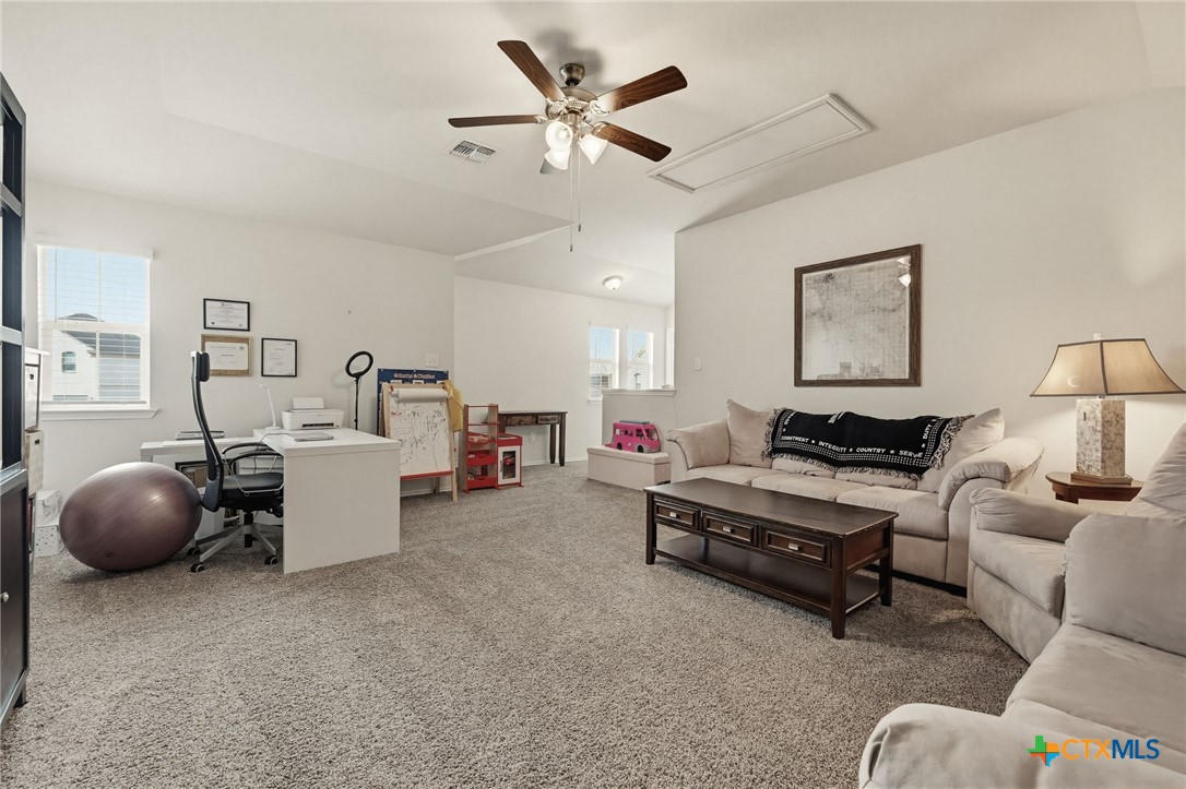 2044 Mallard Court Copperas Cove, TX 76522 - Photo 21 of 41 a living room with furniture and a chandelier