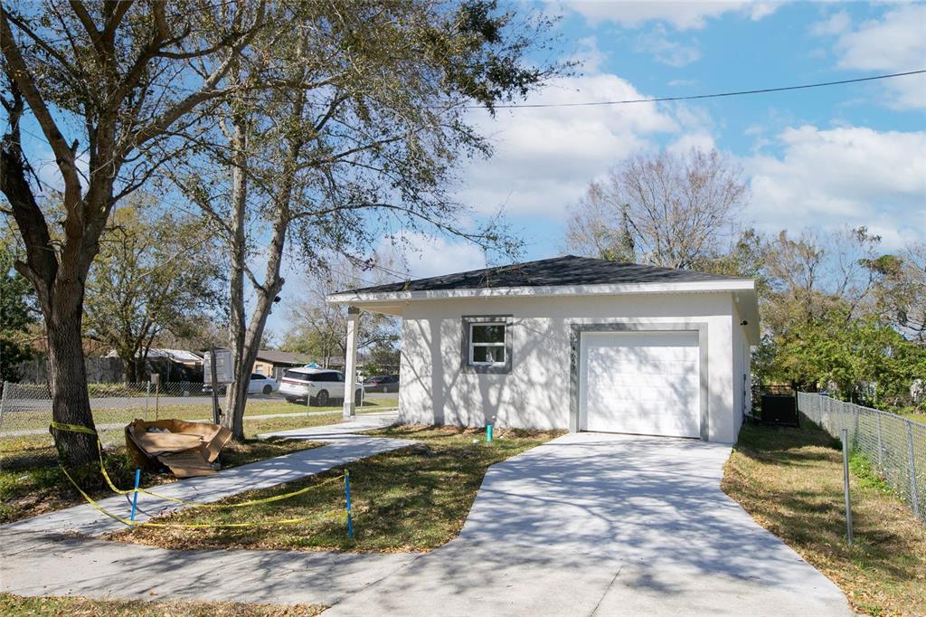 a view of a house with yard and sitting area