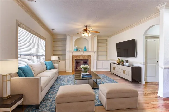 a living room with furniture fireplace and flat screen tv