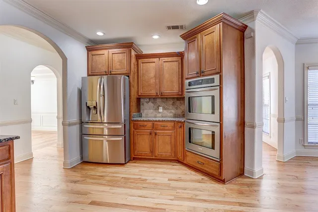 a kitchen with stainless steel appliances granite countertop a sink stove and cabinets