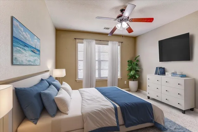 a bedroom with a large bed and a flat screen tv