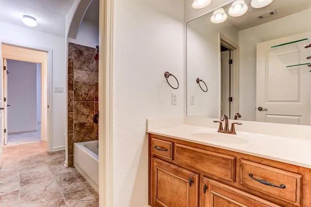 an empty room with fan and windows