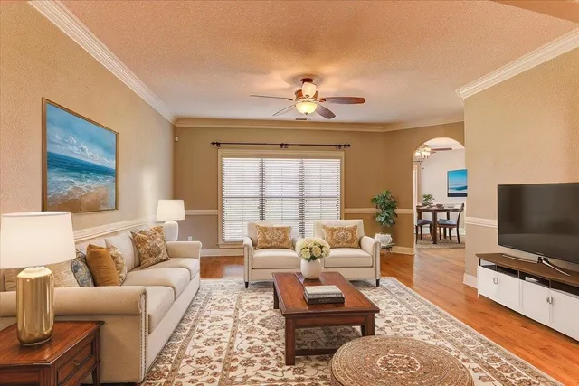 a living room with furniture a rug and a flat screen tv