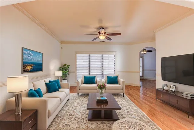 a living room with furniture and a flat screen tv