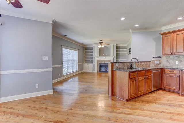 a kitchen with stainless steel appliances granite countertop a stove and a sink
