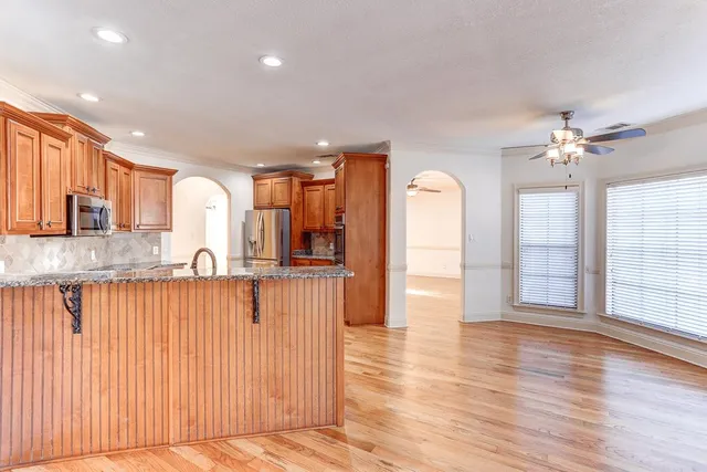 a view of a kitchen with a sink and wooden floor