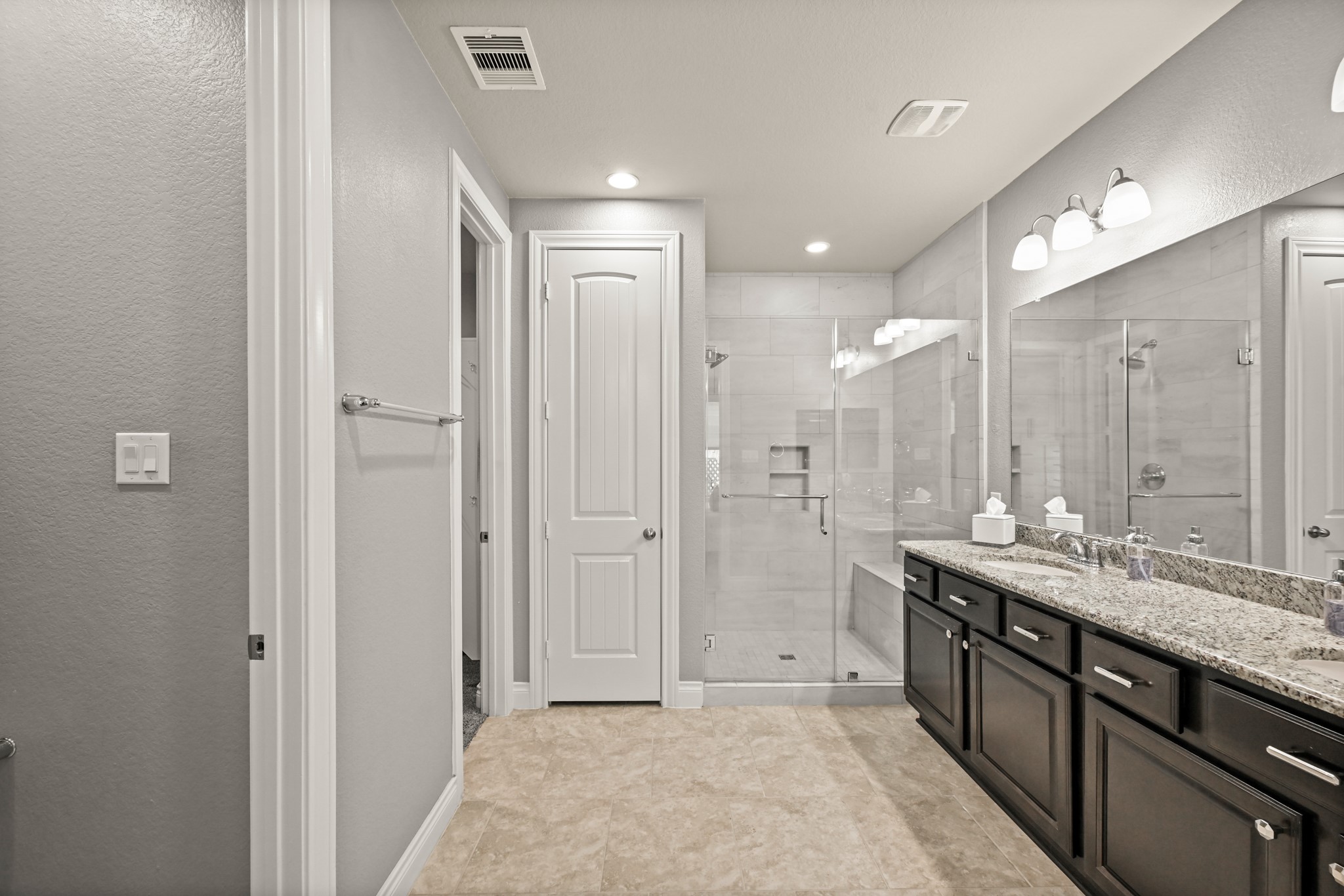 24214 Calico Trace Lane Katy, TX 77494 - Photo 18 of 49 a spacious bathroom with a mirror a shower and a sink