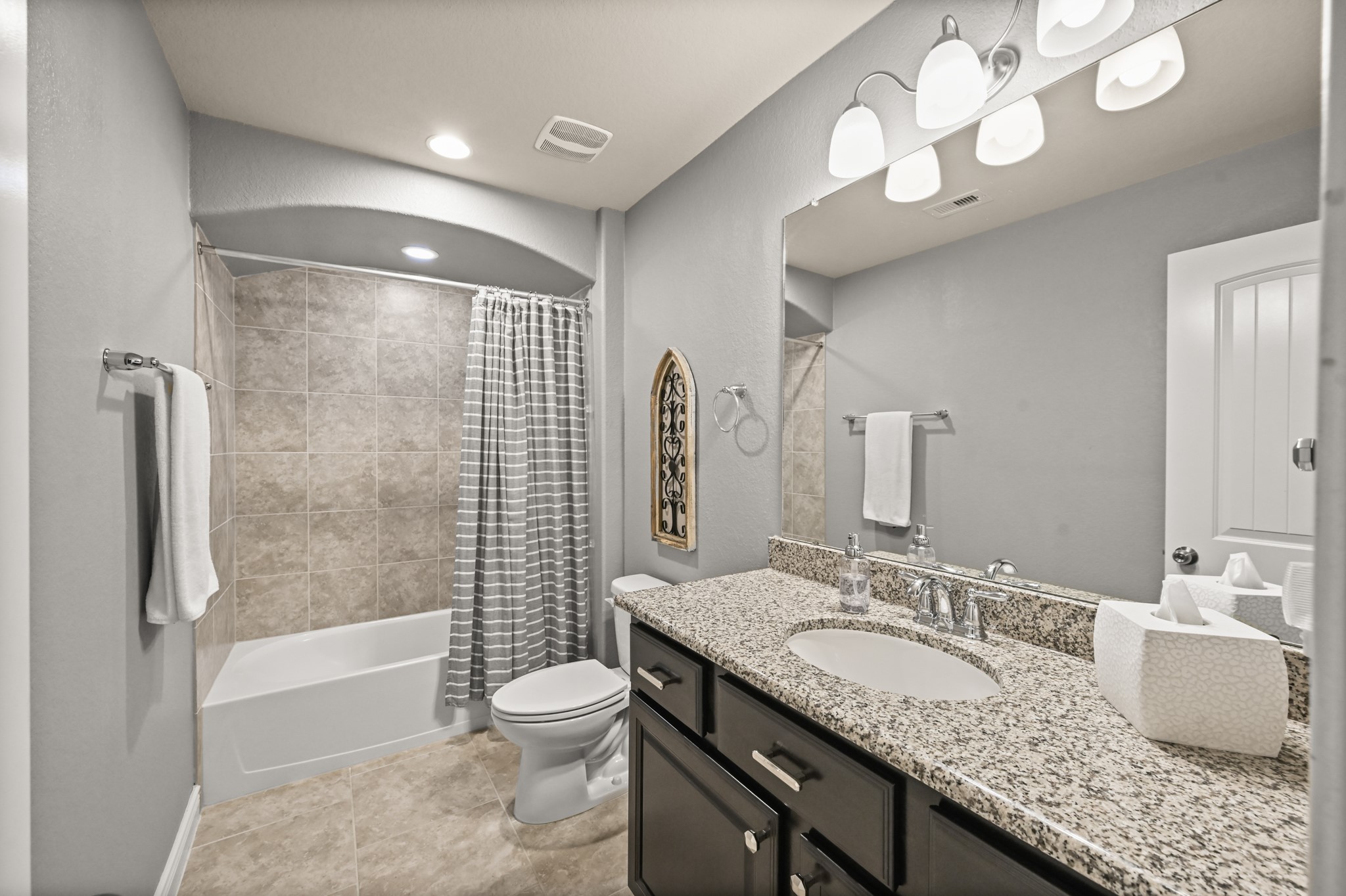 24214 Calico Trace Lane Katy, TX 77494 - Photo 32 of 49 a bathroom with a granite countertop sink a toilet and shower