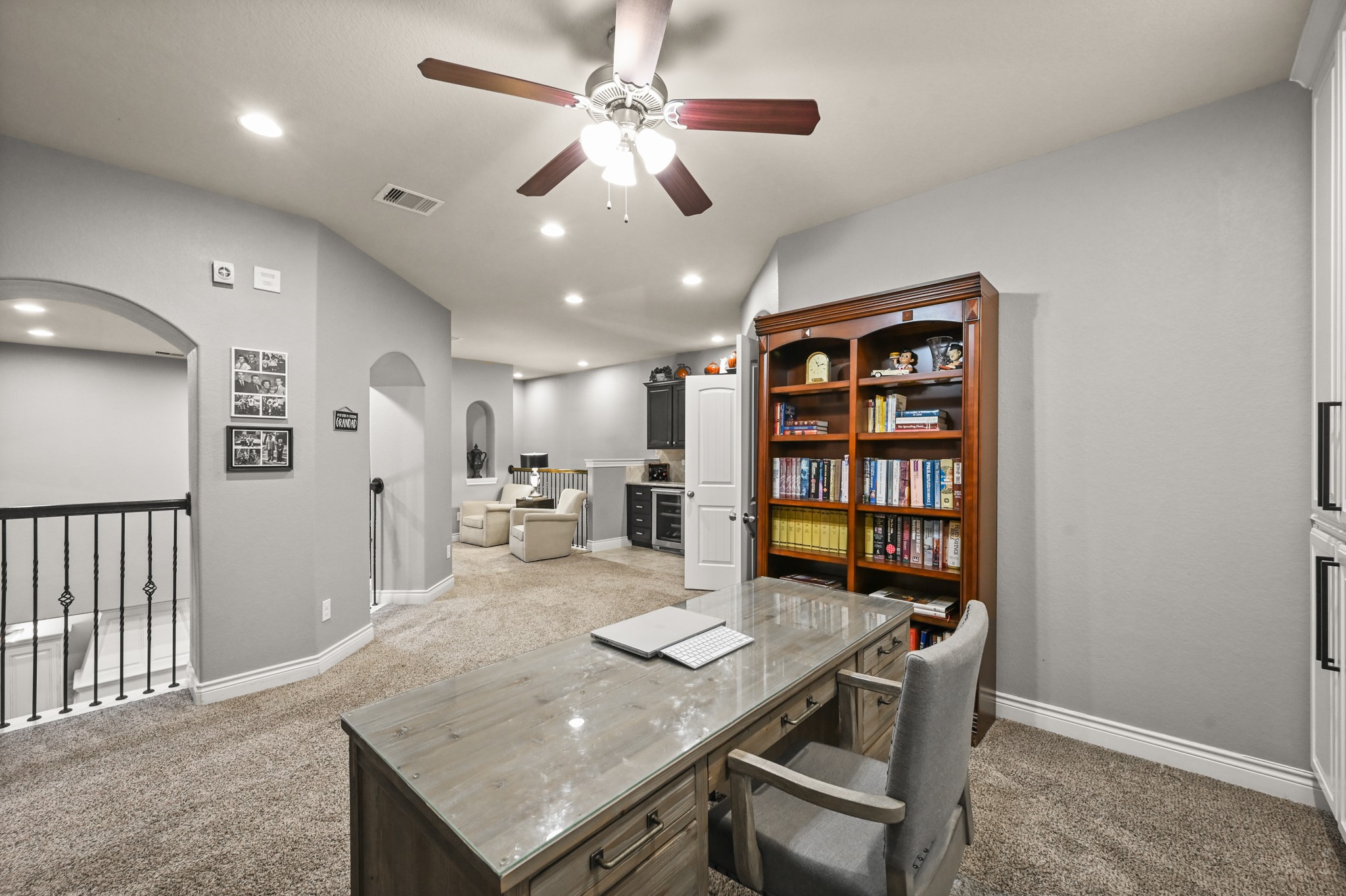 24214 Calico Trace Lane Katy, TX 77494 - Photo 34 of 49 a living room with stainless steel appliances kitchen island granite countertop furniture and a bookshelf