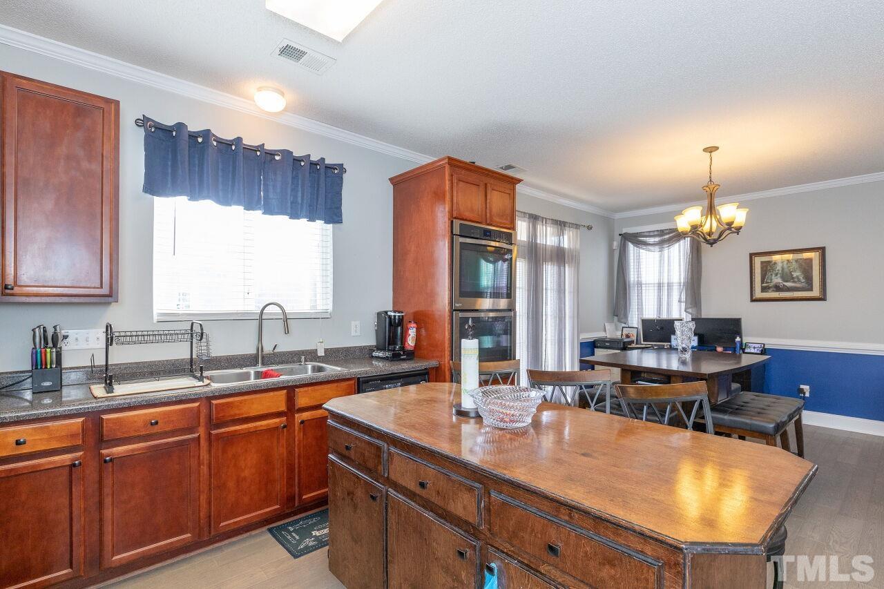6012 Ladish Lane Raleigh, NC 27610 - Photo 13 of 29 a kitchen with sink table and chairs