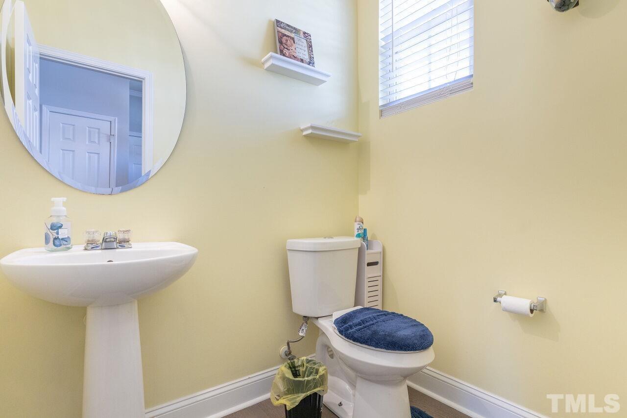 6012 Ladish Lane Raleigh, NC 27610 - Photo 14 of 29 a bathroom with a sink mirror and toilet
