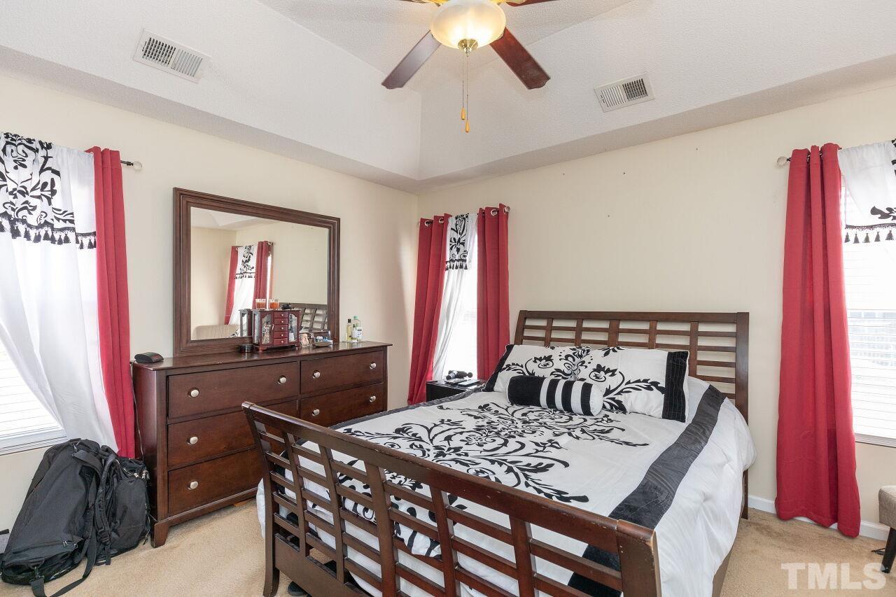 6012 Ladish Lane Raleigh, NC 27610 - Photo 15 of 29 a bed room with a bed and a dresser