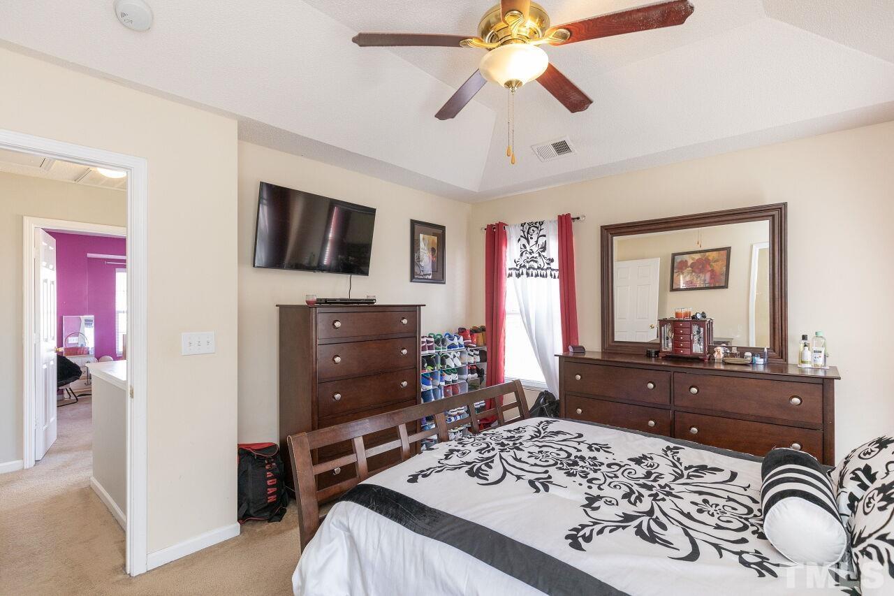 6012 Ladish Lane Raleigh, NC 27610 - Photo 18 of 29 a bedroom with a bed and a flat screen tv