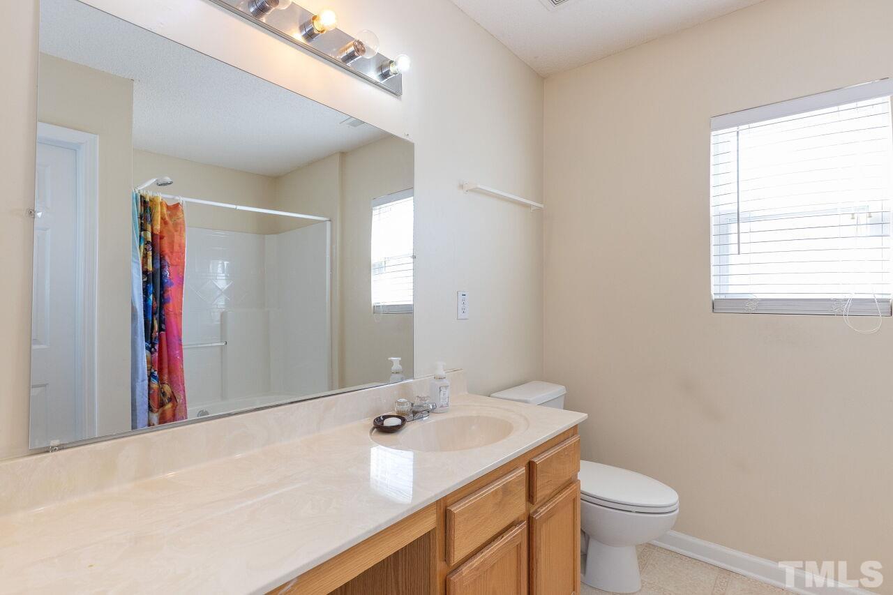 6012 Ladish Lane Raleigh, NC 27610 - Photo 19 of 29 a bathroom with a sink toilet and shower