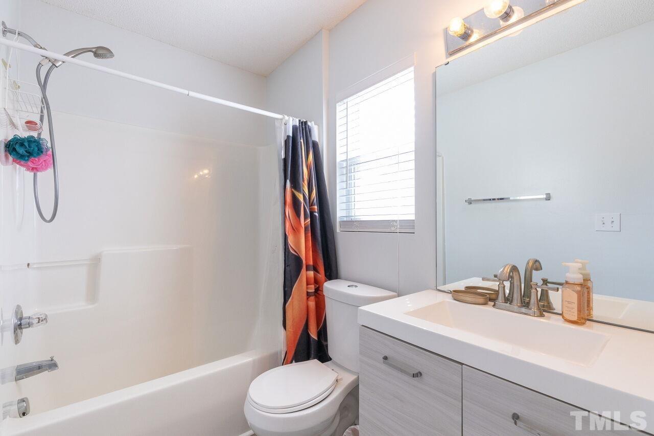6012 Ladish Lane Raleigh, NC 27610 - Photo 23 of 29 a bathroom with a sink toilet and shower
