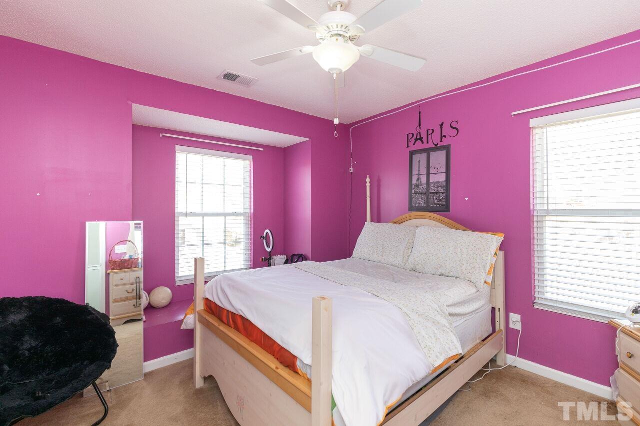 6012 Ladish Lane Raleigh, NC 27610 - Photo 24 of 29 a bedroom with a bed and a dresser