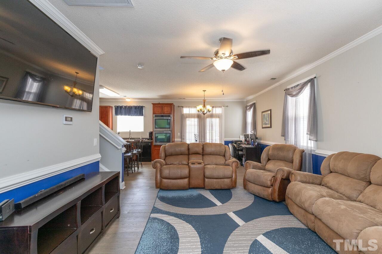 6012 Ladish Lane Raleigh, NC 27610 - Photo 4 of 29 a living room with furniture and a chandelier