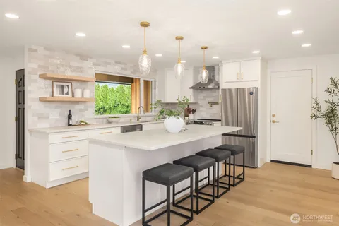 a kitchen with kitchen island cabinets and refrigerator